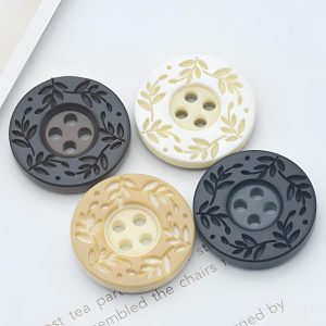 Resin 4-hole patterned buttons in cream and black speckled shades shown together