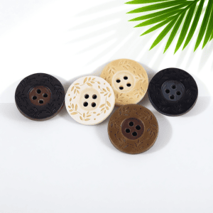 Close up of resin 4-hole patterned buttons in dark brown tones, showing the speckled surface and the four sewing holes