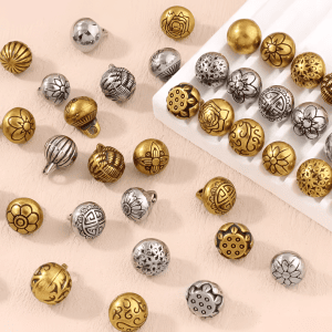 A group of vintage brass shank buttons in a warm brass-tone finish, round metal buttons with a shank back for sewing