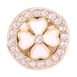 Close up of a mini pearl and rhinestone button, faux pearls set in the centre with a ring of rhinestones around the edge