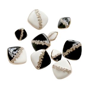 Square rhinestone enamel buttons grouped in black and white with faceted rhinestones in a metal frame