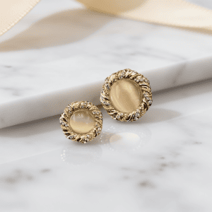 A pair of cat eye rhinestone buttons with a cat-eye stone center and faceted rhinestones