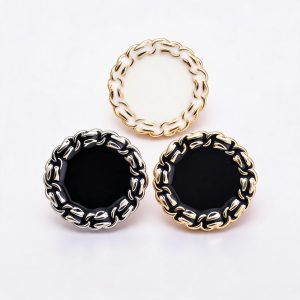 Chain edge buttons with a braided metal rim and enamel center, in gold and silver edges with black and cream centers, for blazers and cardigans
