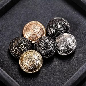 Lion crest buttons with a raised heraldic emblem and beaded metal rim in gold, silver and gunmetal on a dark background, sew-on metal buttons for blazers and coats