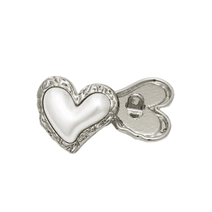 Close-up of a vintage heart pearl button with a faux pearl finish and gold-tone edge