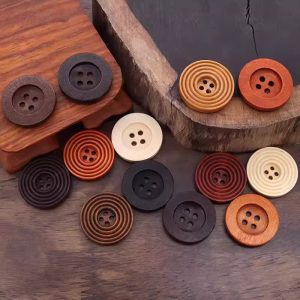 Spiral round wooden buttons on a wooden work surface, natural wood sewing buttons ready for a project