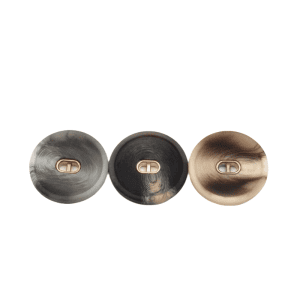 Close-up of patterned resin buttons with a gold center showing the marbled surface and shank back