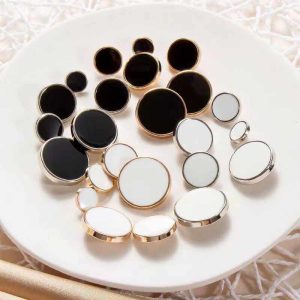 Vintage enamel buttons in black and white with a gold-tone or silver-tone rim, round enamel shank buttons