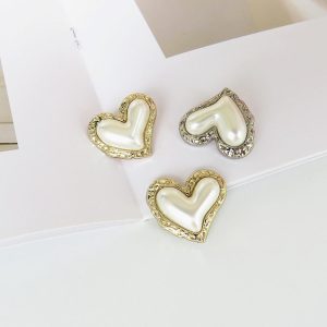 Cream vintage heart pearl buttons with a faux pearl finish and gold-tone edge