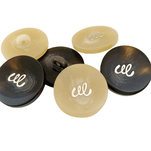 Assorted resin monogram buttons in black and cream with a gold-tone monogram