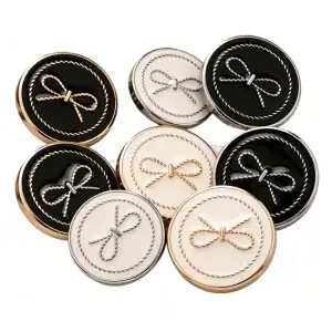 Group of round bow enamel buttons with metal frames in black and cream, with gold-tone and silver-tone rope bow motifs