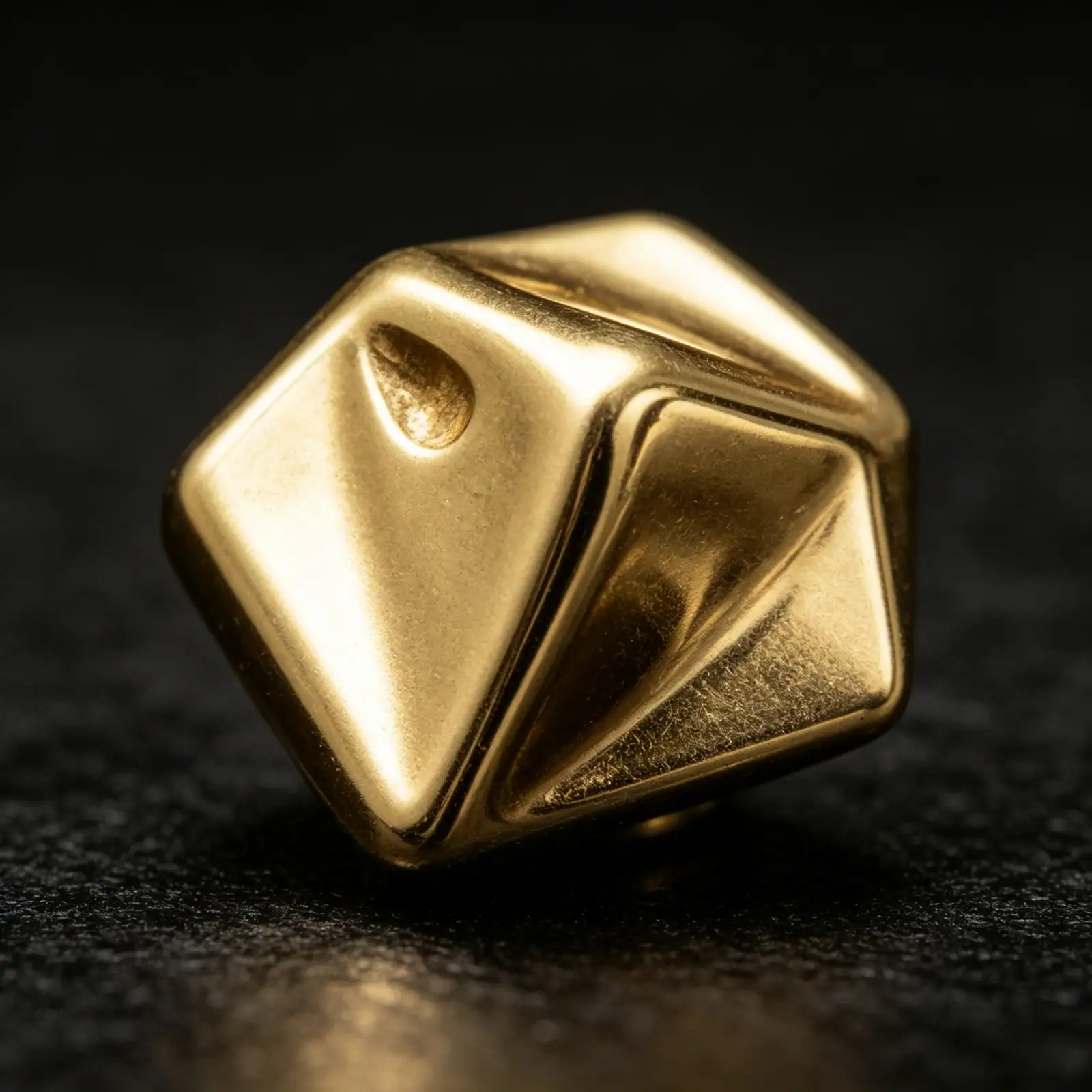 Close-up of a gold-tone cone metal button with shank back