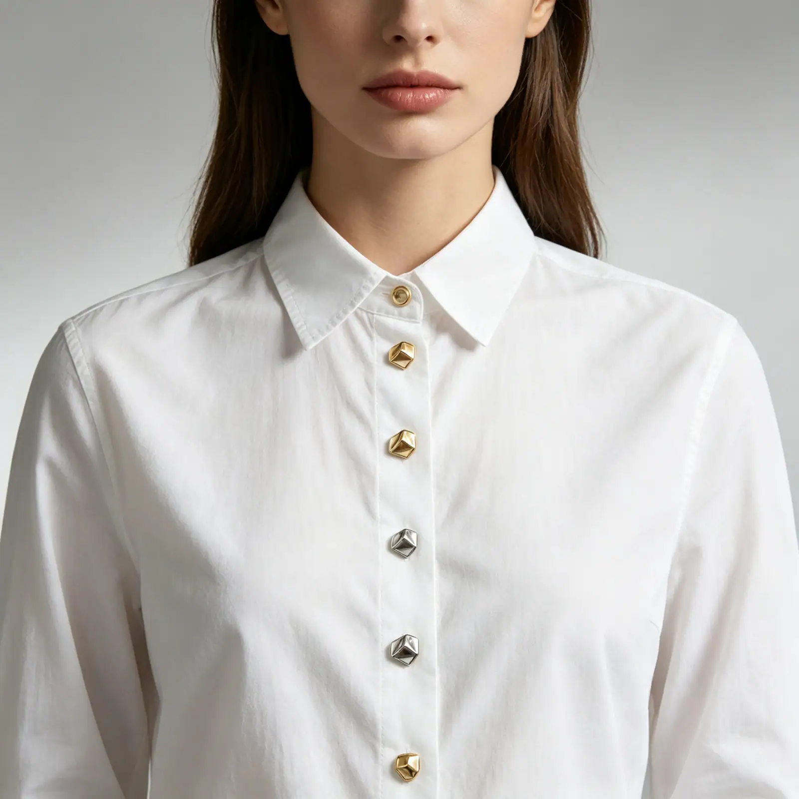White shirt fastened with gold-tone and silver-tone cone metal buttons