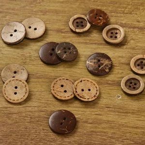 Natural coconut buttons scattered on a wooden surface, round coconut shell sew-through buttons