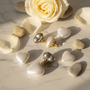 Heart faux pearl button with a gold flower styled beside a rose