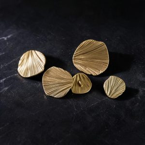 Metal ginkgo leaf buttons in matte gold with a fan-shaped leaf design and radiating pleats, sew-on buttons for coats, blazers and cardigans