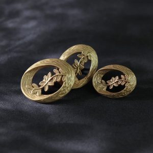 Laurel leaf buttons, vintage gold openwork oval metal sew-on buttons with a woven rim and leaf sprig
