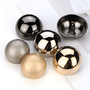 Mushroom dome buttons in gold, silver, gunmetal and matte tones with a smooth metal half-ball shape and shank back, for coats and knitwear
