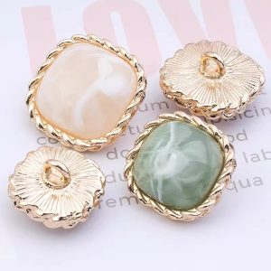 Assorted marble resin buttons with gold trim in pink, green and cream marbled tones