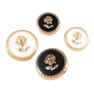 Assorted rose enamel metal buttons in black and cream with a gold-tone rose design