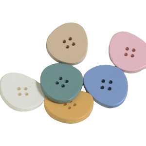 Triangle resin buttons in soft pastel colors arranged together, rounded triangle sew-through buttons