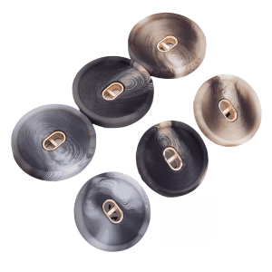 Assorted patterned resin buttons with a gold center in marbled brown and grey tones
