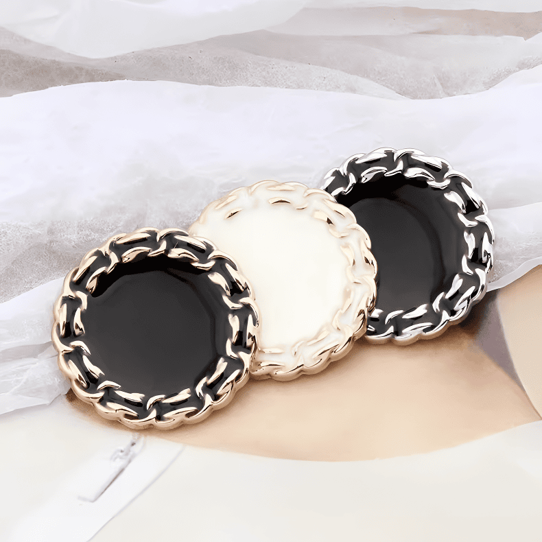 Vintage chain edge buttons with braided metal rims and enamel centers, in gold and silver with black and cream centers, for blazers and cardigans