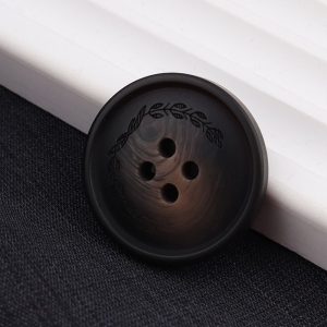 Front view of a dark brown resin leaf pattern button with an embossed leaf design