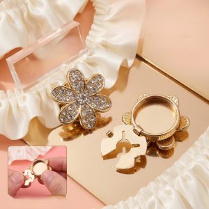 Rhinestone flower button covers clipped onto a shirt cuff