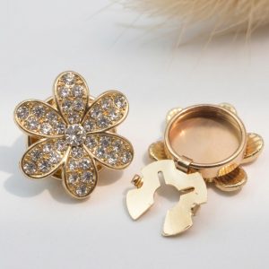 Front of the rhinestone flower button cover showing the six petals fully set with rhinestones and a center stone