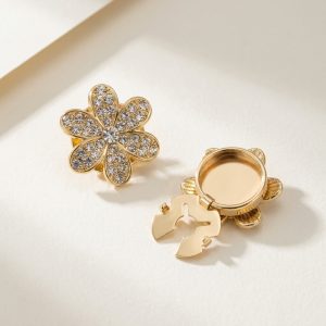 Rhinestone flower button covers with a gold-tone six-petal frame fully set with rhinestones, snap-on, sold as a pair