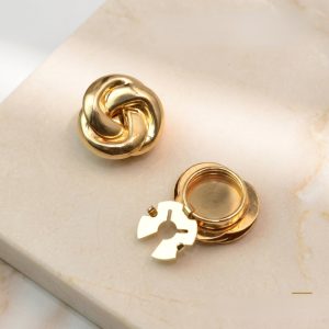 A pair of gold knot cufflink covers with a twisted knot design, snap-on, no-sew cufflink-style covers