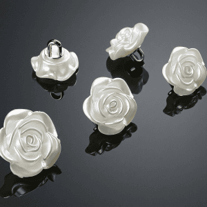 White faux pearl rose buttons showing the raised shank back for sewing