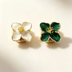 White and green enamel flower button covers with gold-tone petals and back clips