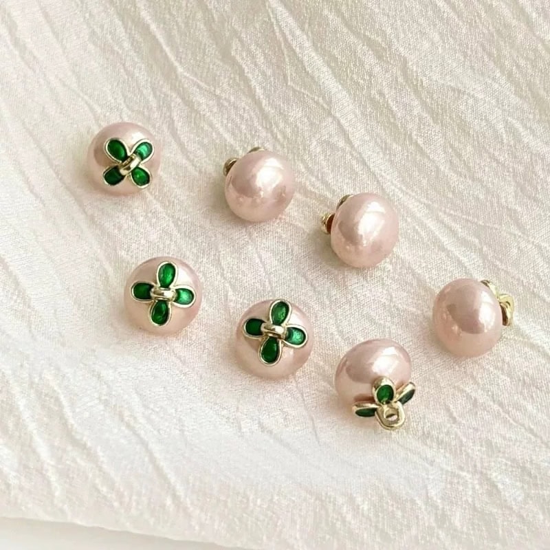 Close-up of the green enamel flower on the faux pearl flower button