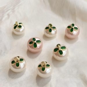 Faux pearl flower buttons in ivory and pink shown side by side