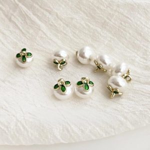 Back of the faux pearl flower button showing the gold-tone metal shank loop
