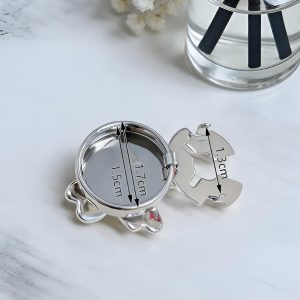 Back of a French cuff flower button cover showing the silver-tone metal base and hinged clip, with a flower face about 1.7cm outer and 1.5cm inner and a 1.3cm clip
