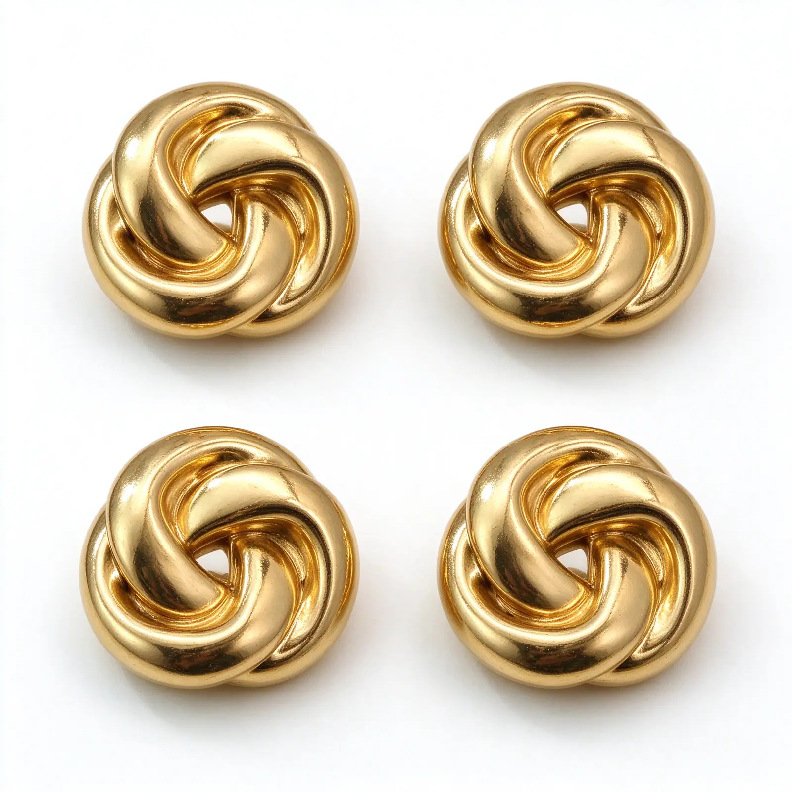 Four gold-tone knot cufflink covers arranged on a white background