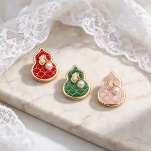 Red, green and pink gourd pearl metal buttons on a marble slab with white lace