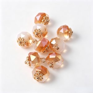Champagne and blush pink faceted flower base buttons mixed together on a white surface, showing the difference between the two shades