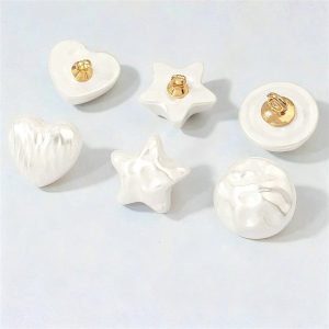 White faux pearl buttons in heart, star and round dome shapes, smooth and rippled baroque style finishes with gold-tone metal shanks