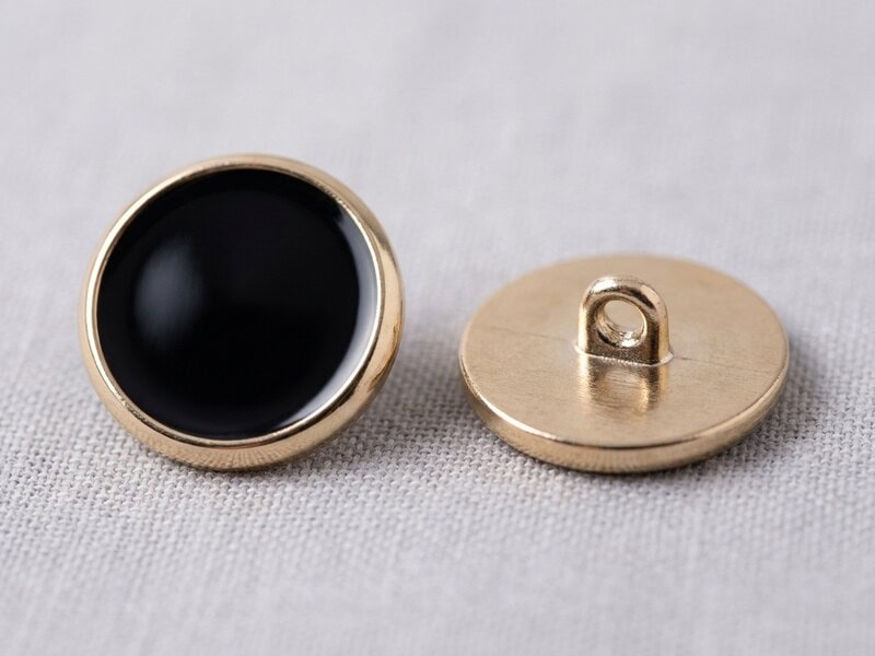 Enamel buttons shown face up and face down with the gold-tone metal shank loop on the back