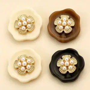 Pearl cluster flower buttons in cream, marbled brown and black, each with a gold-tone flower holding six faux pearls