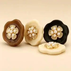 Pearl cluster flower buttons standing on edge showing the raised gold flower above the resin base