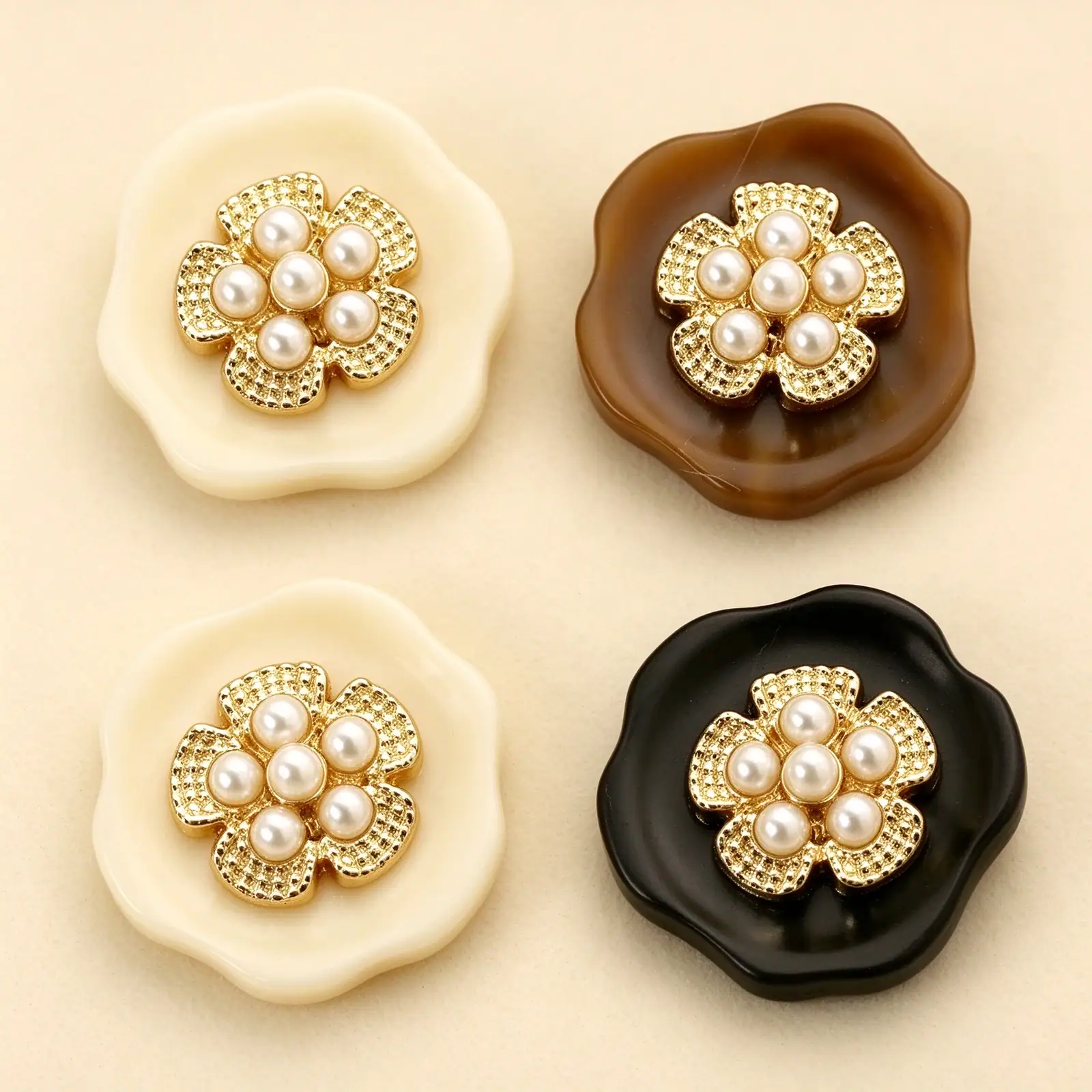Pearl cluster flower buttons in cream, marbled brown and black, each with a gold-tone flower holding six faux pearls