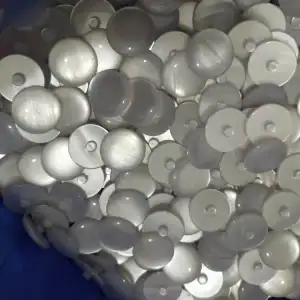 Bulk stock of white and grey pearlescent resin buttons