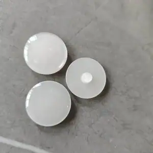 Close-up of the shank back on white pearlescent resin buttons