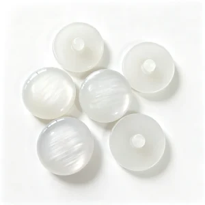 White pearlescent resin buttons with shank back on a white background