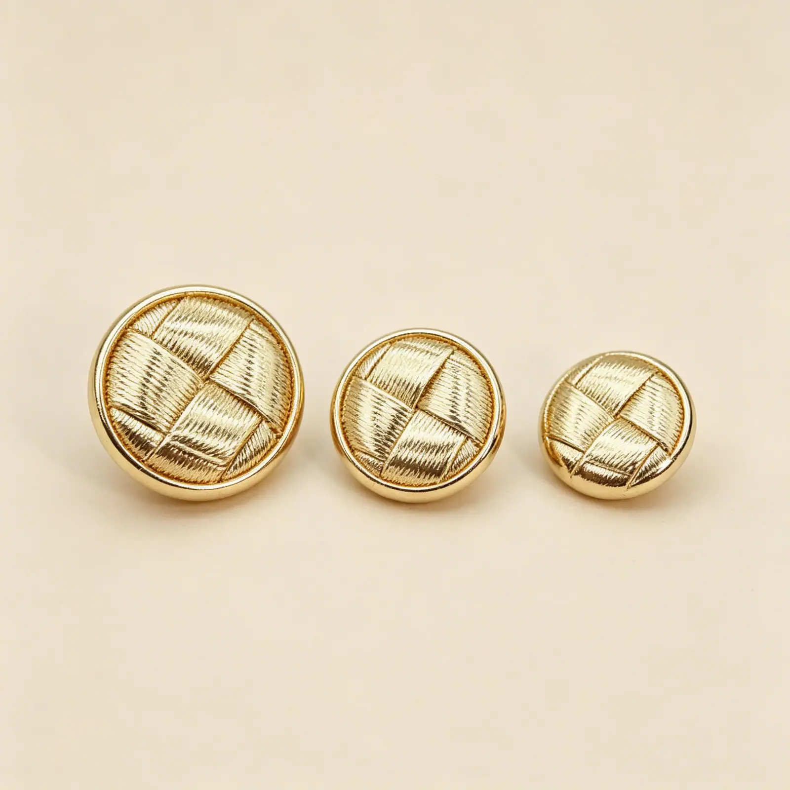 Size guide showing 22.5mm, 18mm and 15mm round woven gold buttons side by side
